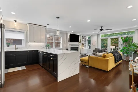 a kitchen with kitchen island granite countertop a sink counter top space and stainless steel appliances