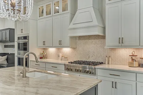 a kitchen with stainless steel appliances granite countertop a stove and a sink