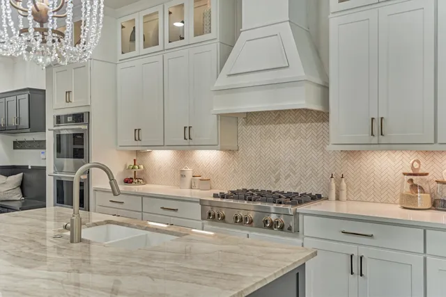 a kitchen with stainless steel appliances granite countertop a stove and a sink