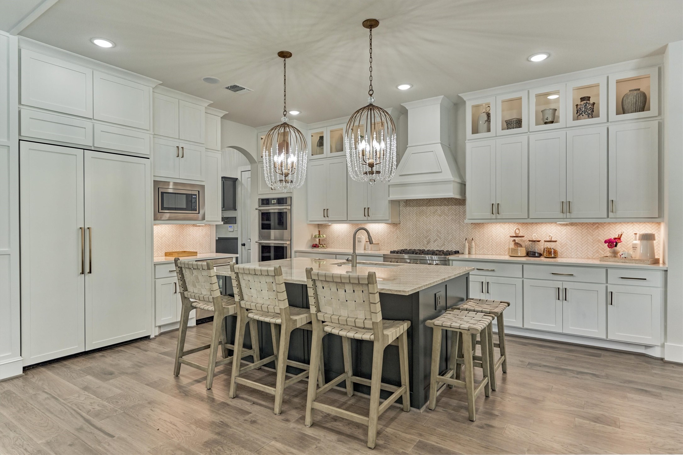 2017 Bennet Lane Conroe, TX 77384 - Photo 12 of 50 a kitchen with stainless steel appliances kitchen island granite countertop a dining table chairs and white cabinets