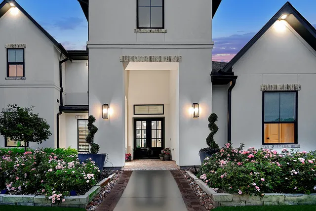 a front view of a house with a garden