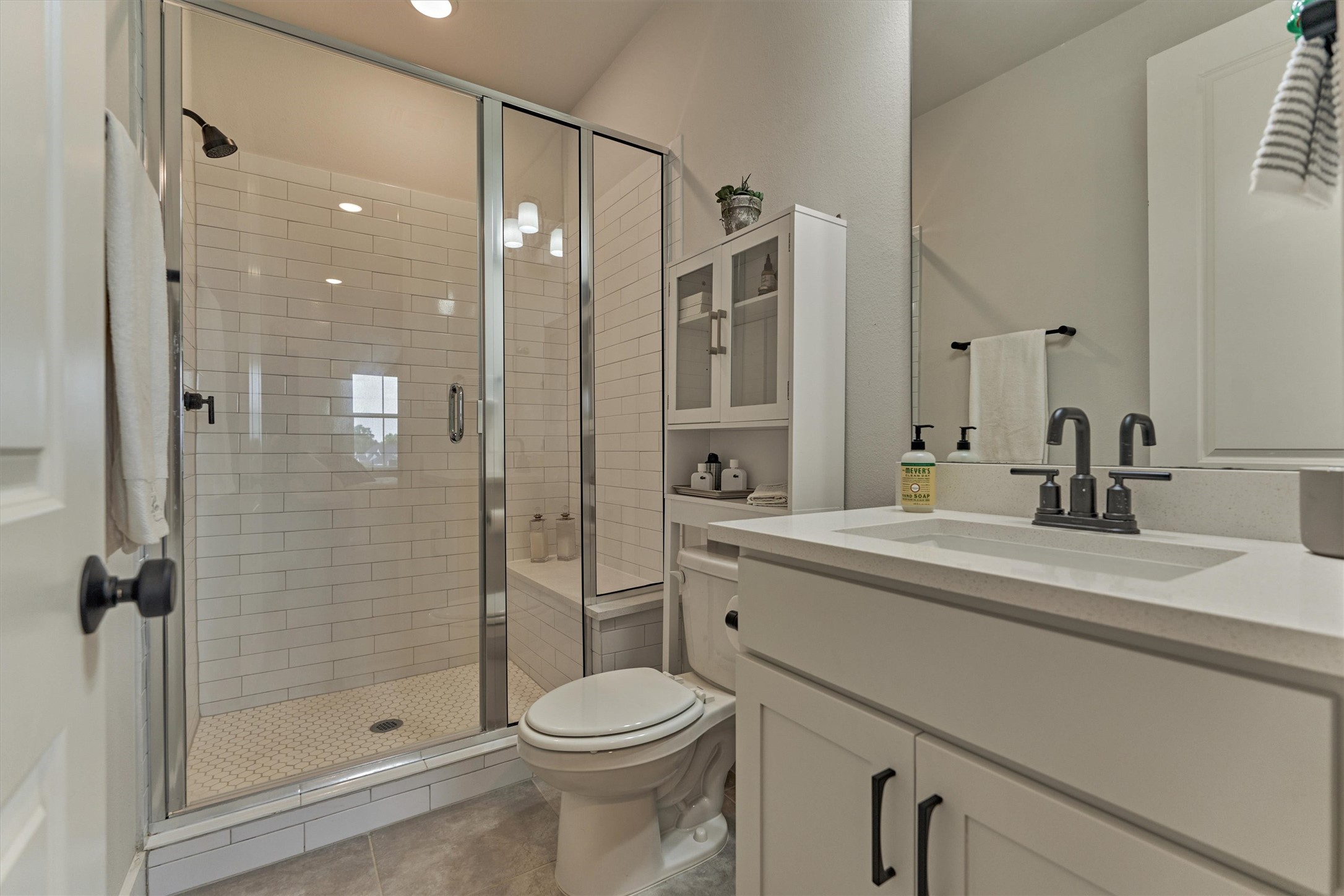 2017 Bennet Lane Conroe, TX 77384 - Photo 34 of 50 a bathroom with a shower sink vanity mirror and toilet