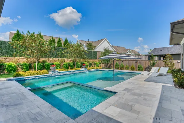 a view of a house with pool and chairs