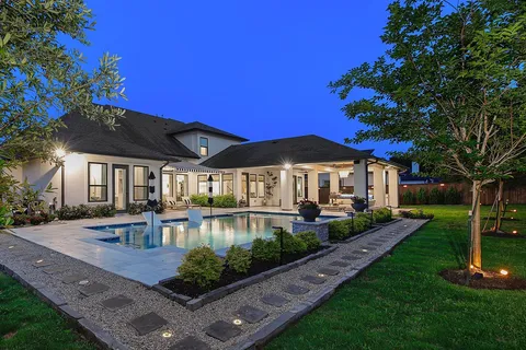 a view of a house with swimming pool and a yard