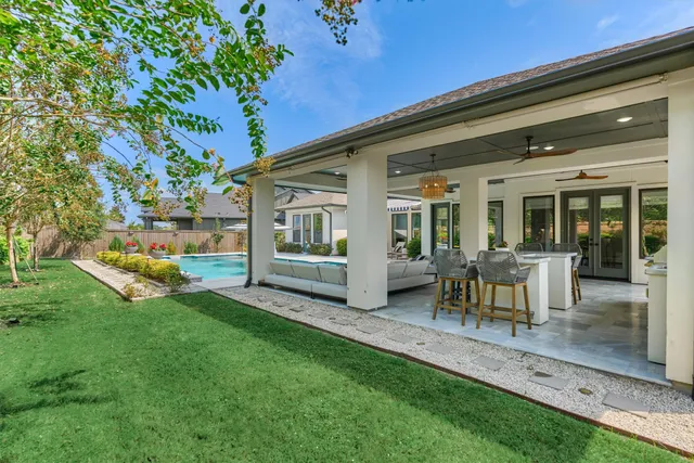 a view of a house with backyard sitting area and porch