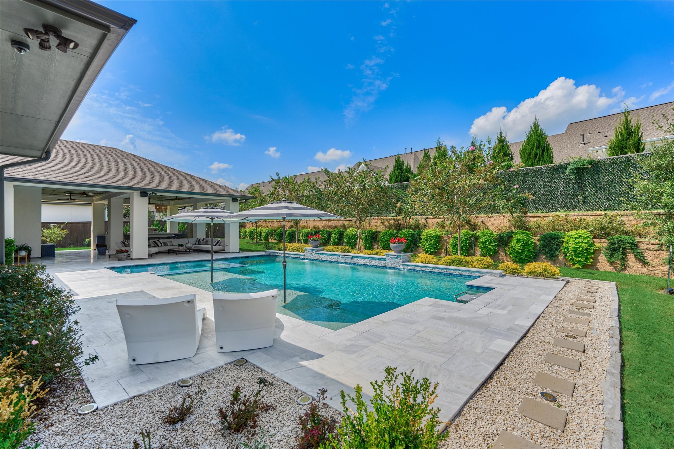 2017 Bennet Lane Conroe, TX 77384 - Photo 45 of 50 a view of a patio with a table and chairs under an umbrella