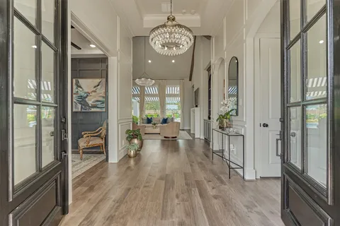 a very nice looking room with wooden floor and a large mirror
