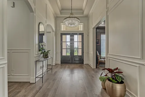 a view of an entryway with wooden floor