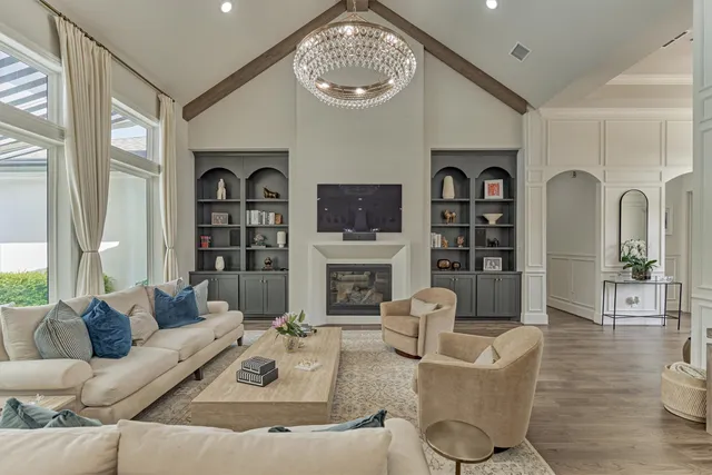 a living room with fireplace furniture and a large window