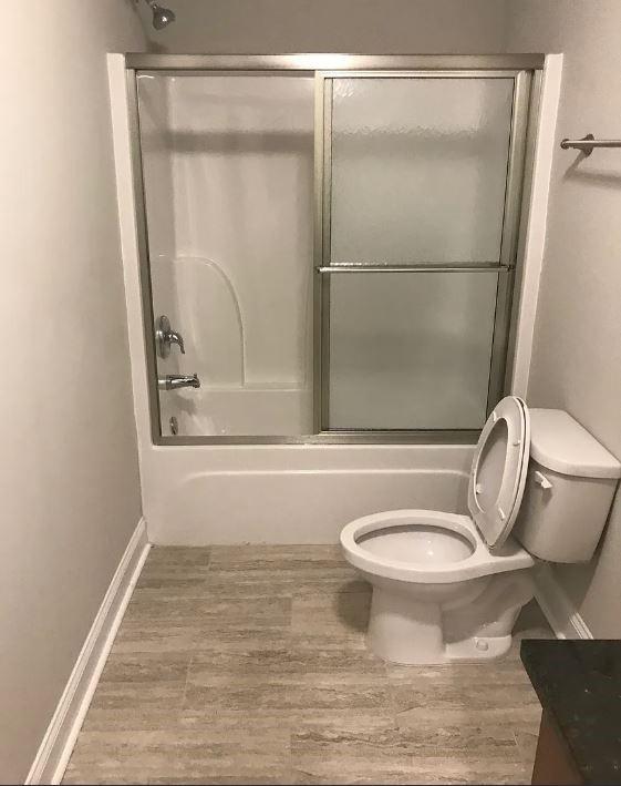 1071 Level Creek Road, Unit E3 Buford, GA 30518 - Photo 12 of 12 a bathroom with a toilet and a shower