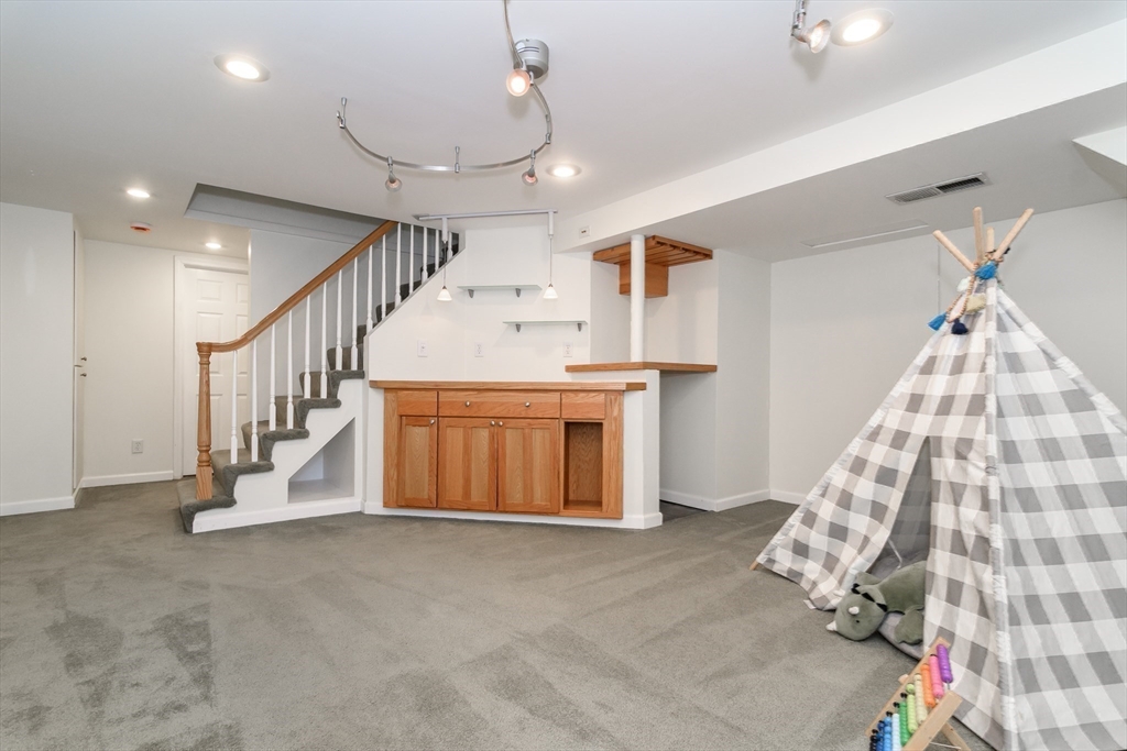 4 Pryor Road Natick, MA 01760 - Photo 17 of 24 a view of entryway with stairs and cabinet