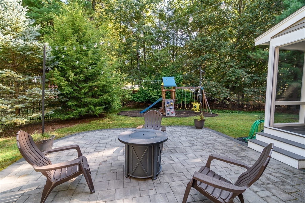 4 Pryor Road Natick, MA 01760 - Photo 22 of 24 a view of a chair and table in backyard of the house