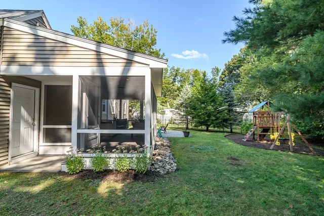 a view of a house with backyard and sitting area