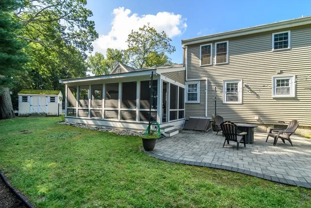 a view of a house with backyard sitting area and garden