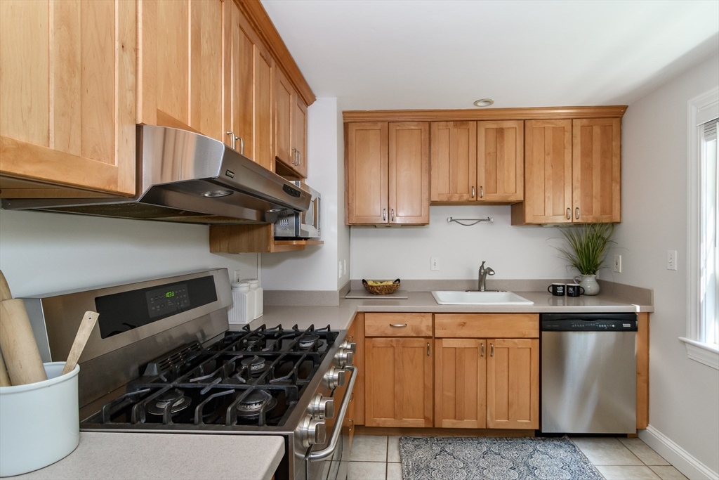 4 Pryor Road Natick, MA 01760 - Photo 5 of 24 a kitchen with stainless steel appliances a stove a sink a refrigerator and cabinets
