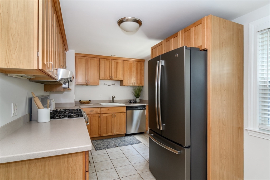 4 Pryor Road Natick, MA 01760 - Photo 6 of 24 a kitchen with stainless steel appliances granite countertop a refrigerator sink and cabinets