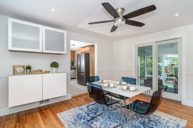 a living room with stainless steel appliances kitchen island granite countertop furniture and a rug