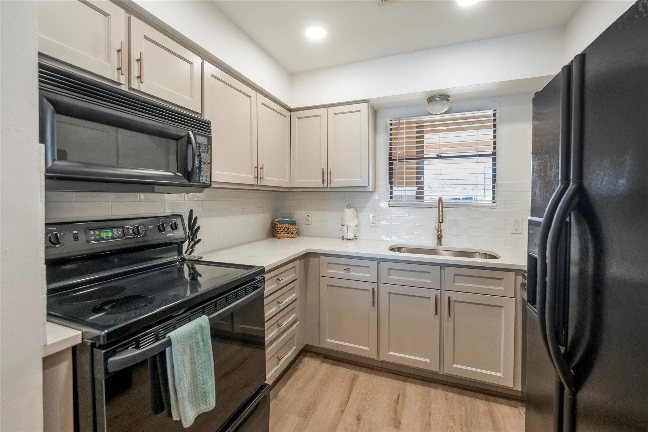 202 Lakeview Terrace, Unit A Conroe, TX 77356 - Photo 14 of 45 a kitchen with a sink stove and refrigerator