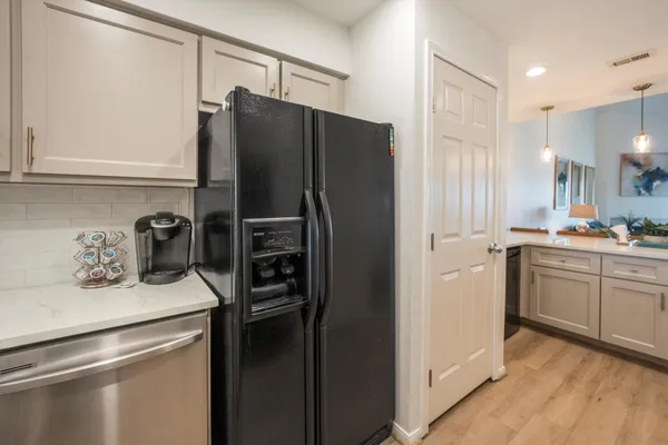 a kitchen with cabinets stainless steel appliances and a counter space