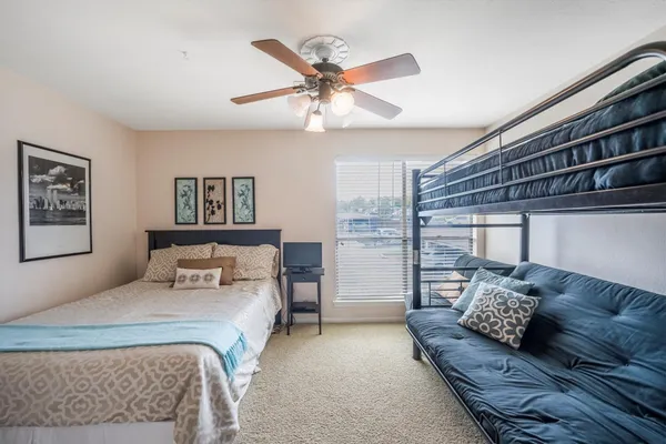 a bedroom with a bed and a window