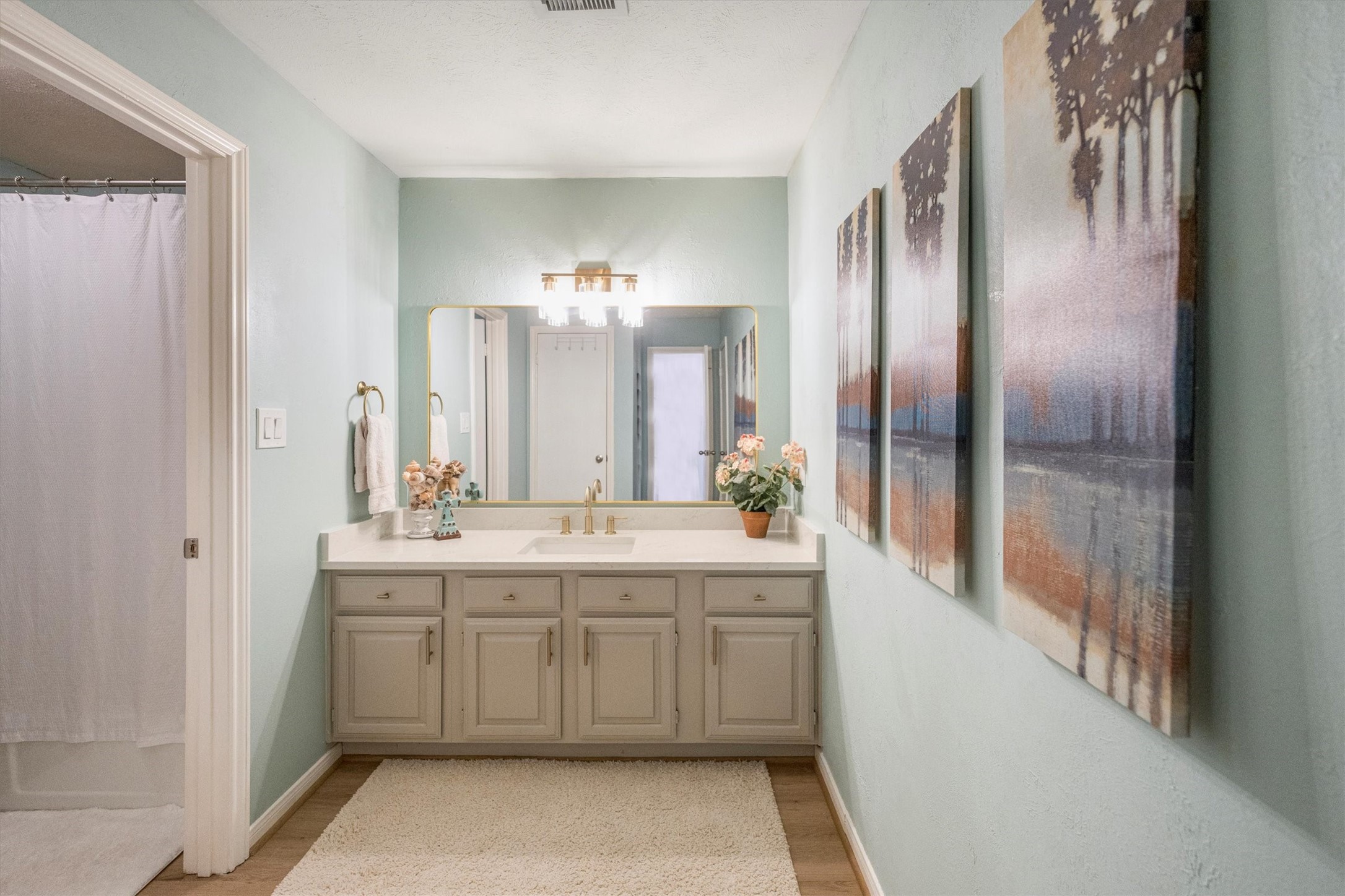 202 Lakeview Terrace, Unit A Conroe, TX 77356 - Photo 20 of 45 a bathroom with a double vanity sink and mirror