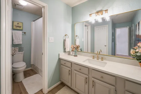 a white toilet sitting next to a white sink