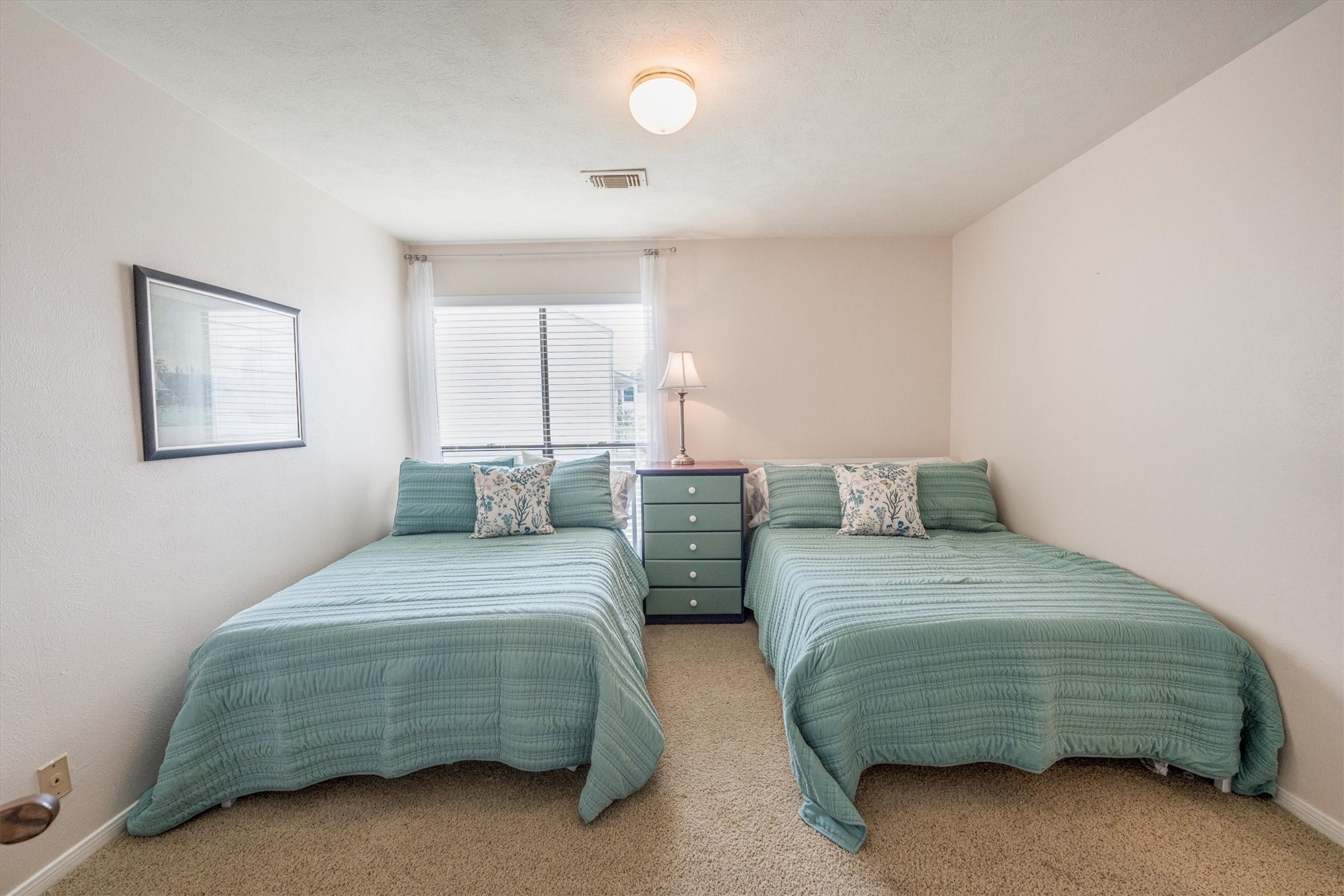 202 Lakeview Terrace, Unit A Conroe, TX 77356 - Photo 25 of 45 a bedroom with a bed and a cabinets