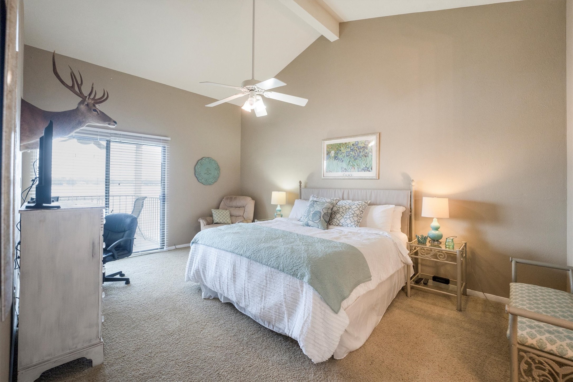 202 Lakeview Terrace, Unit A Conroe, TX 77356 - Photo 26 of 45 a spacious bedroom with a bed and a chandelier