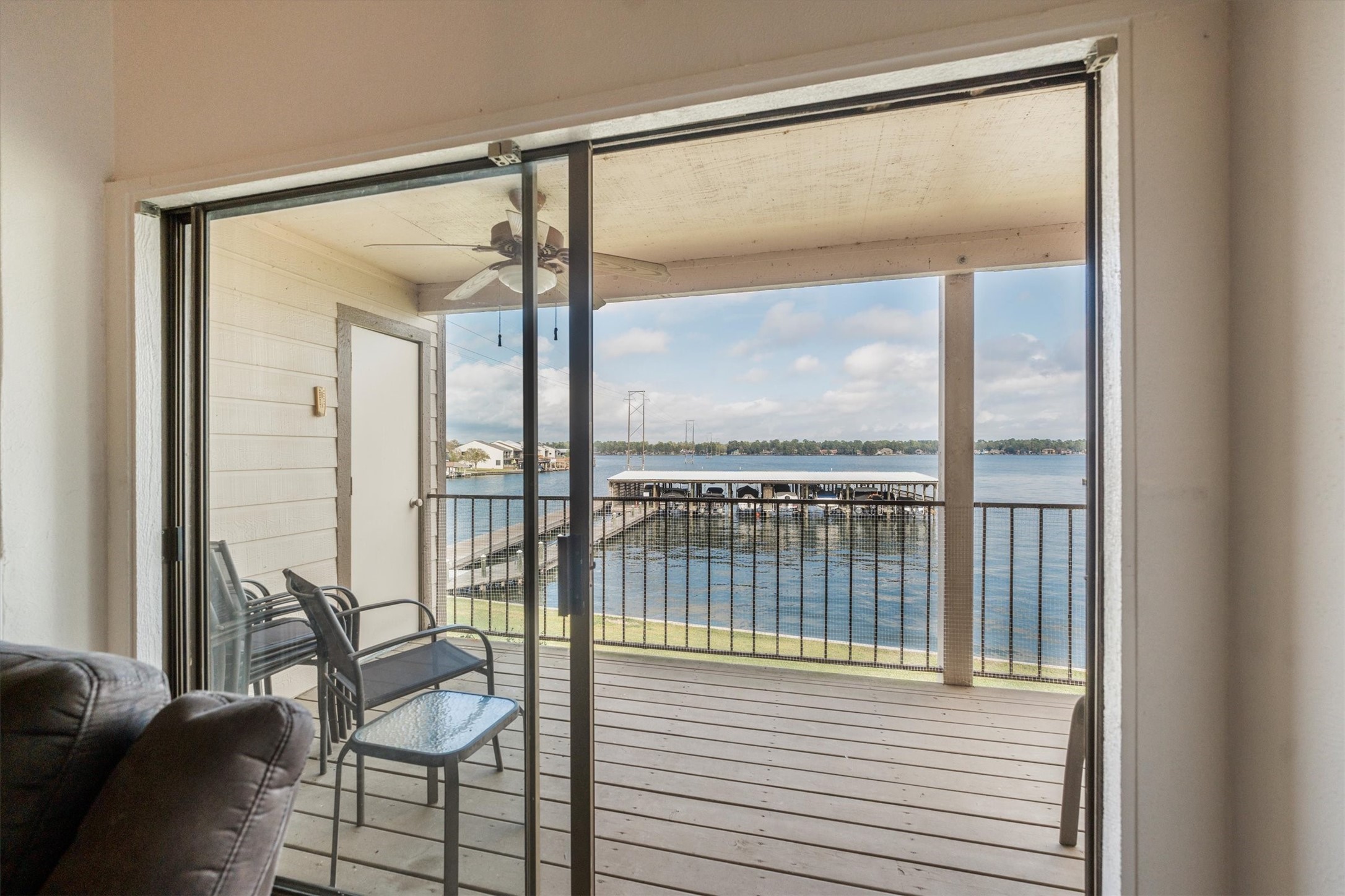 202 Lakeview Terrace, Unit A Conroe, TX 77356 - Photo 33 of 45 a view of a balcony with chairs and floor to ceiling window