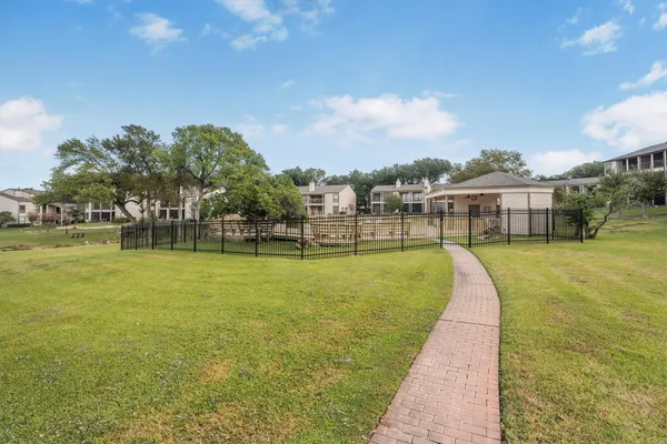 a view of a swimming pool and a yard