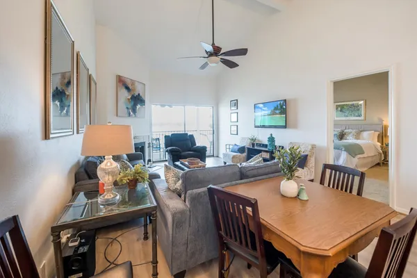 a living room with furniture and a dining table
