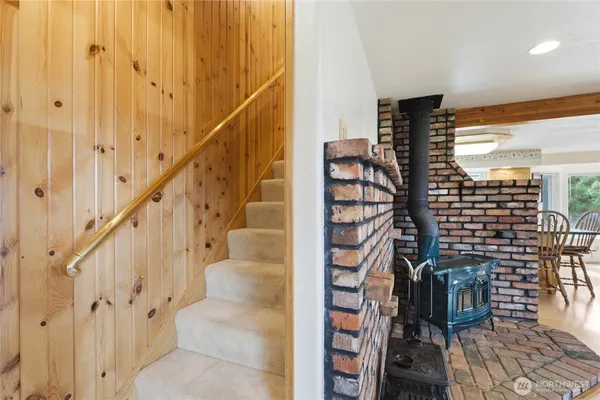 a bedroom with a bed a dresser and window
