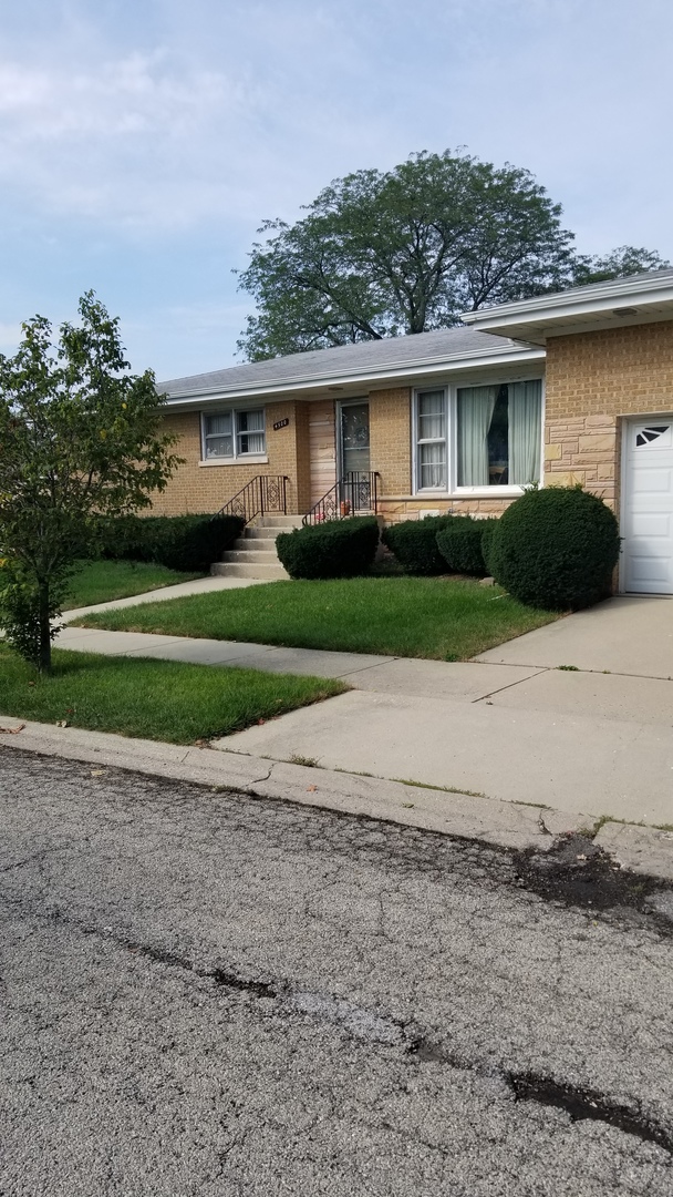 4500 Plainfield Avenue Norridge, IL 60706 - Photo 1 of 29 a front view of a house with a yard and a garage