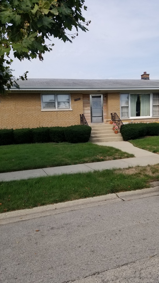 4500 Plainfield Avenue Norridge, IL 60706 - Photo 2 of 29 a front view of a house with a yard and garage