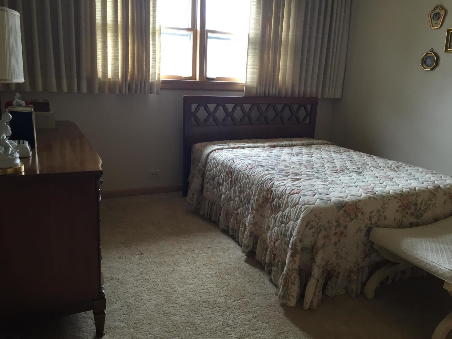 4500 Plainfield Avenue Norridge, IL 60706 - Photo 12 of 29 a bed sitting in a bedroom next to a window