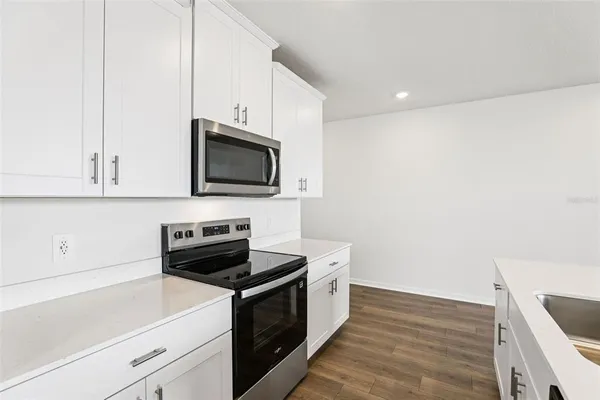a kitchen with a sink and a stove top oven