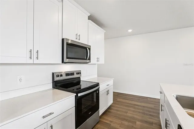 a kitchen with a sink and a stove top oven