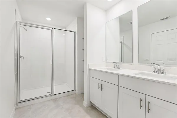 a bathroom with a double vanity sink and mirror