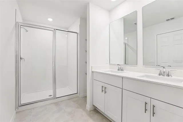 a bathroom with a double vanity sink and mirror