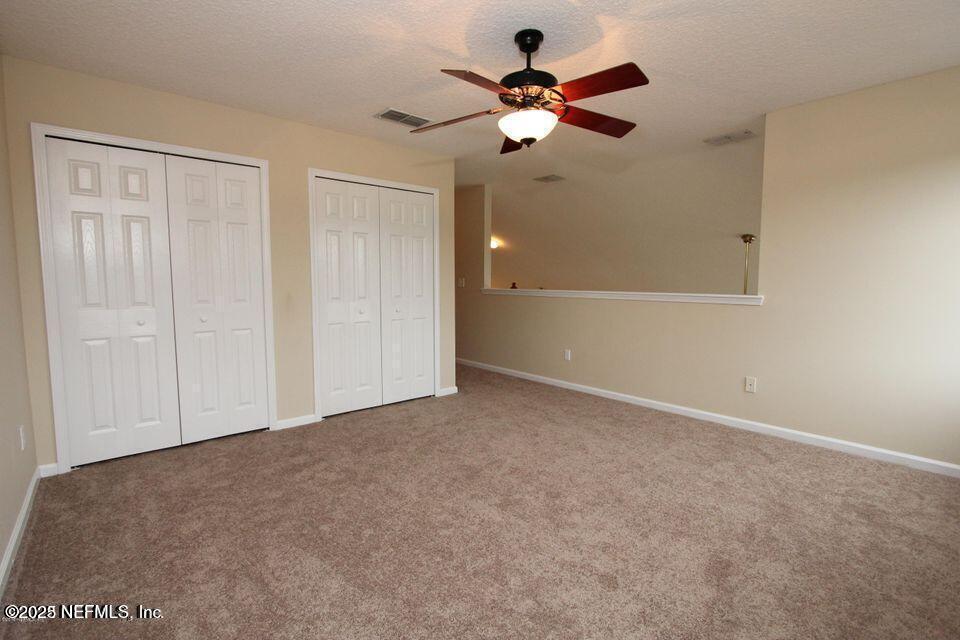 1288 Loch Tanna Loop St. Johns, FL 32259 - Photo 14 of 25 a view of an empty room with a ceiling fan