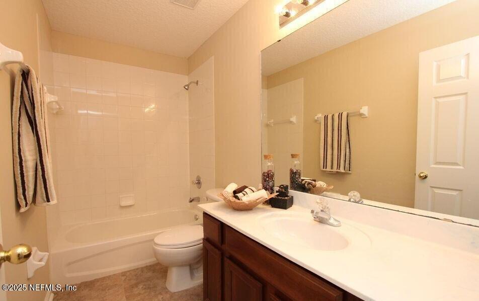 1288 Loch Tanna Loop St. Johns, FL 32259 - Photo 17 of 25 a bathroom with a double vanity sink toilet and shower