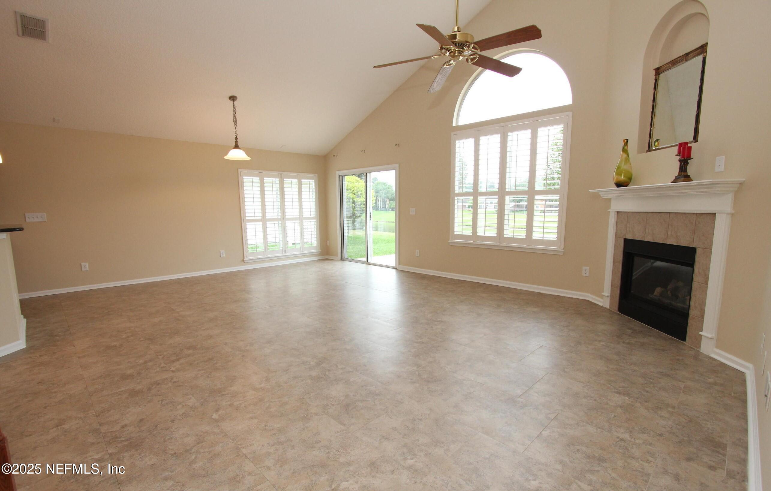 1288 Loch Tanna Loop St. Johns, FL 32259 - Photo 7 of 25 an empty room with windows and fireplace