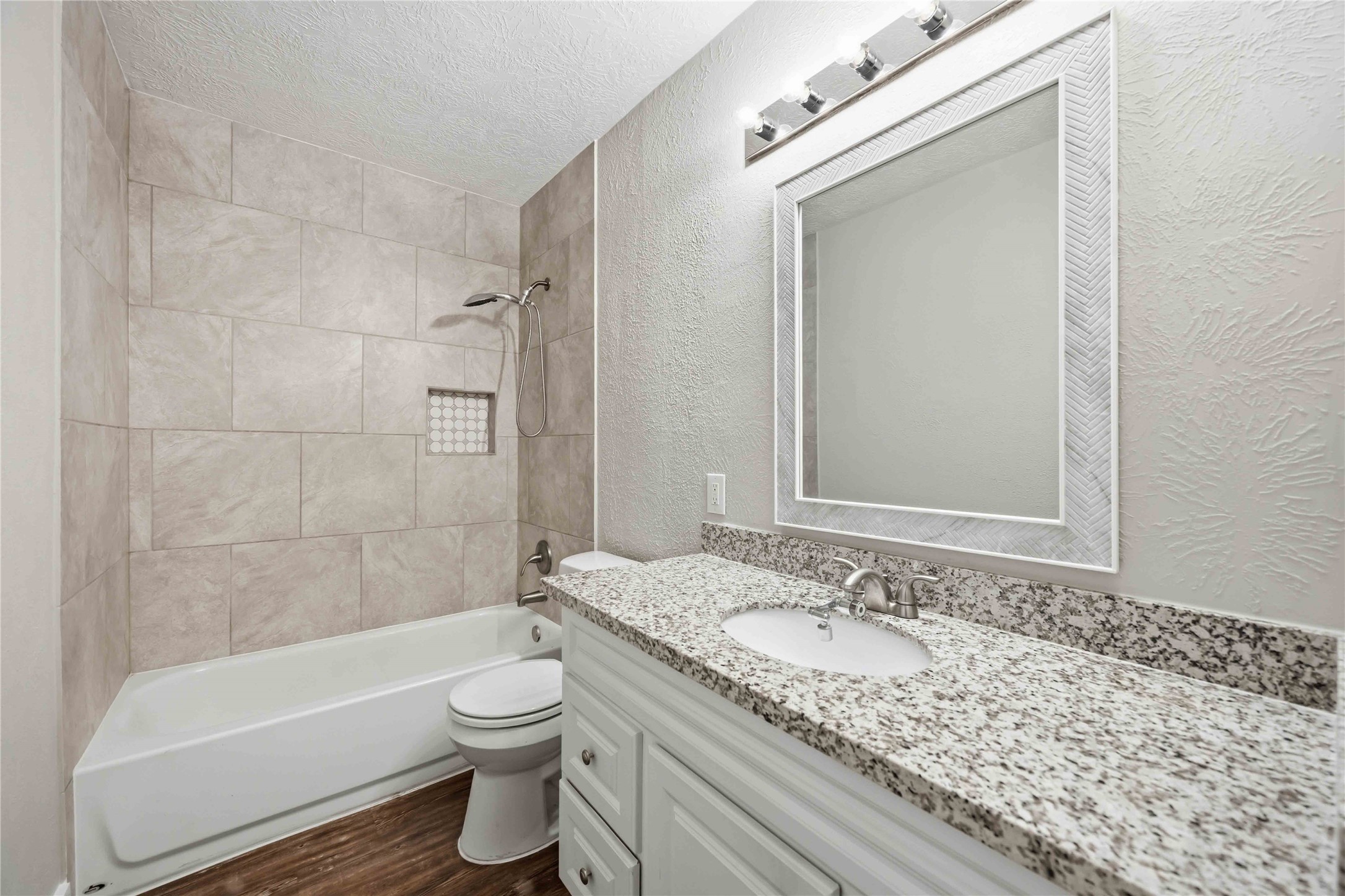 113 East Witcher Lane Houston, TX 77076 - Photo 13 of 21 a bathroom with a granite countertop sink a toilet and bathtub