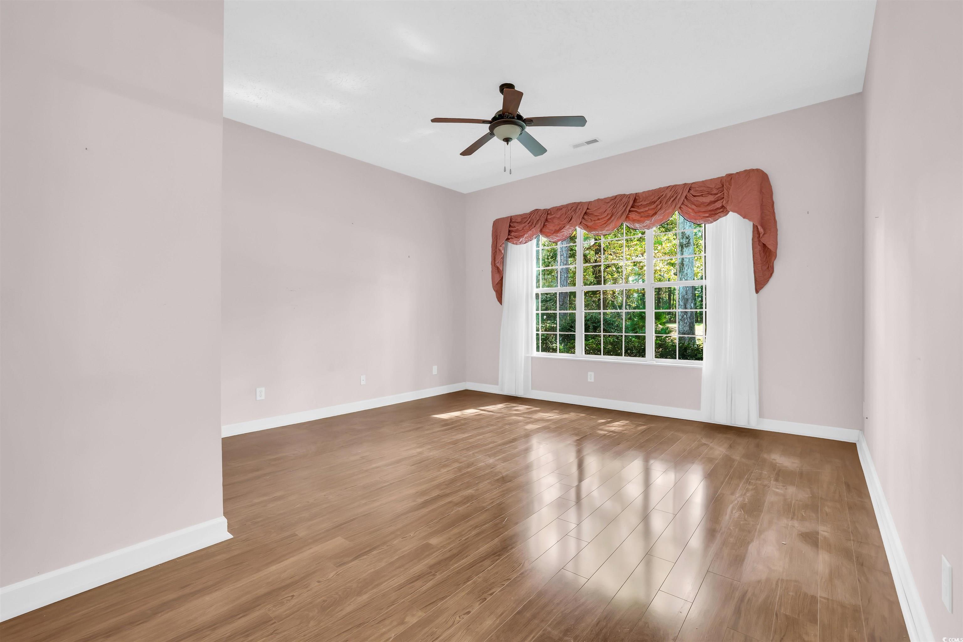 9350 Pinckney Lane Murrells Inlet, SC 29576 - Photo 13 of 40 Spare room featuring light wood-style floors and a ceiling fan