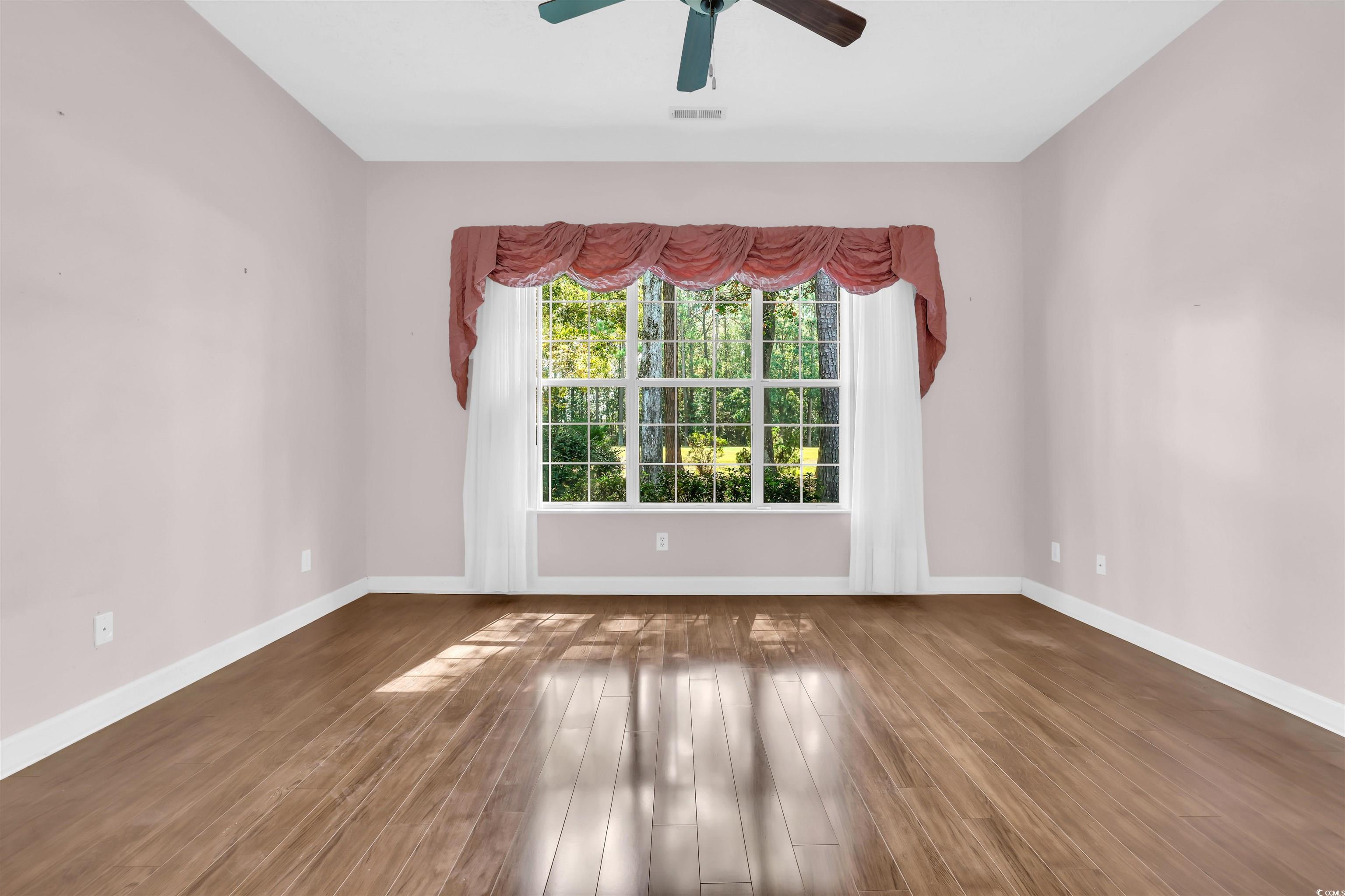9350 Pinckney Lane Murrells Inlet, SC 29576 - Photo 15 of 40 Spare room featuring wood finished floors and a ceiling fan