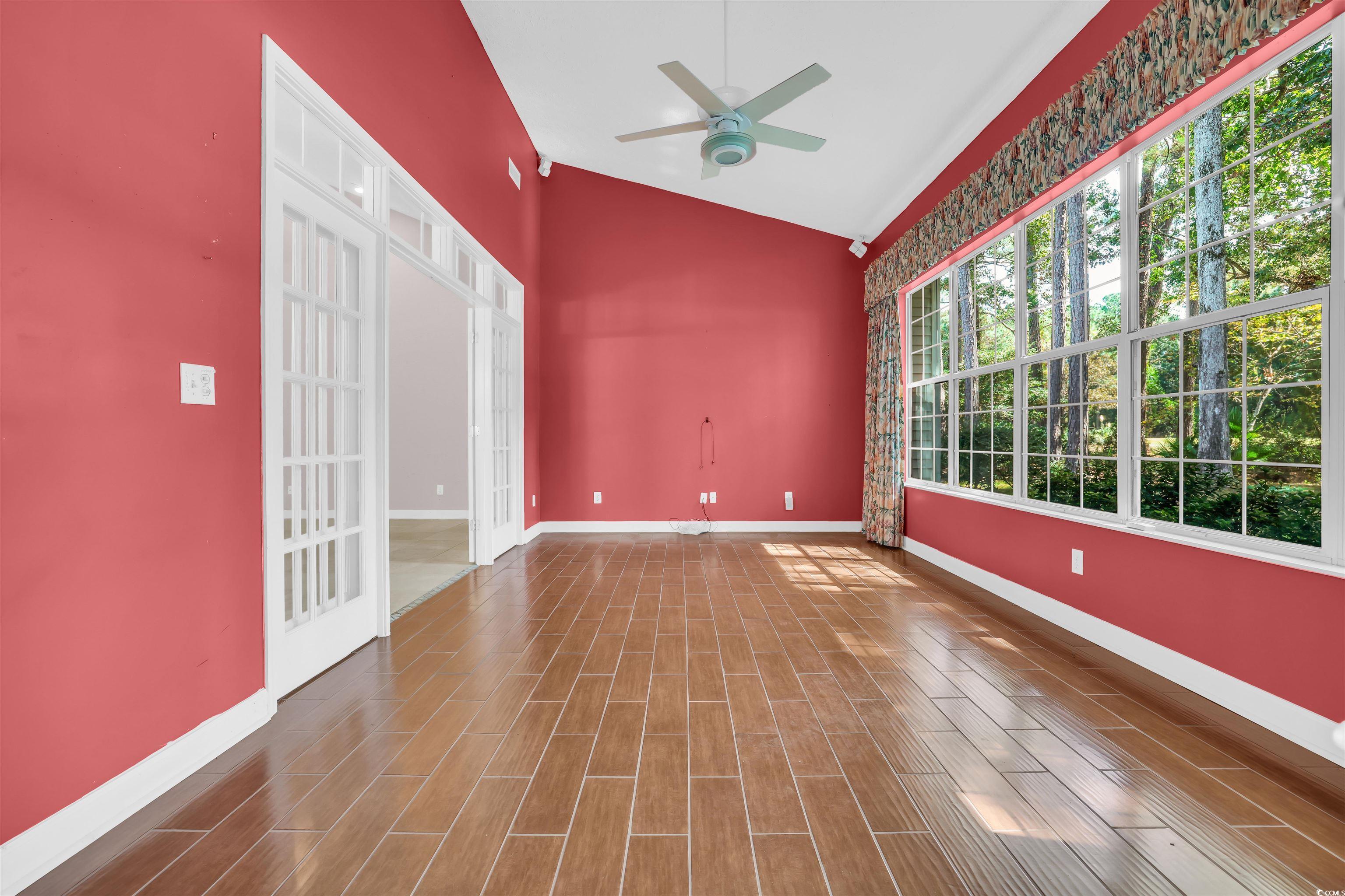 9350 Pinckney Lane Murrells Inlet, SC 29576 - Photo 20 of 40 Empty room featuring wood finish floors, ceiling fan, and high vaulted ceiling