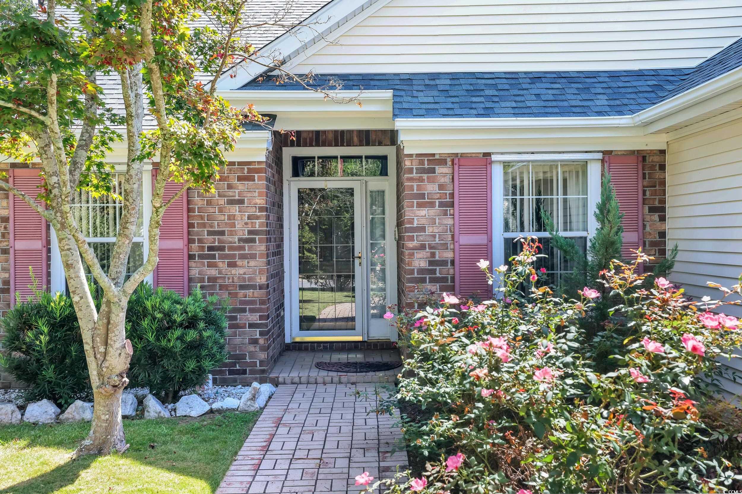 9350 Pinckney Lane Murrells Inlet, SC 29576 - Photo 2 of 40 View of exterior entry featuring a shingled roof and brick siding