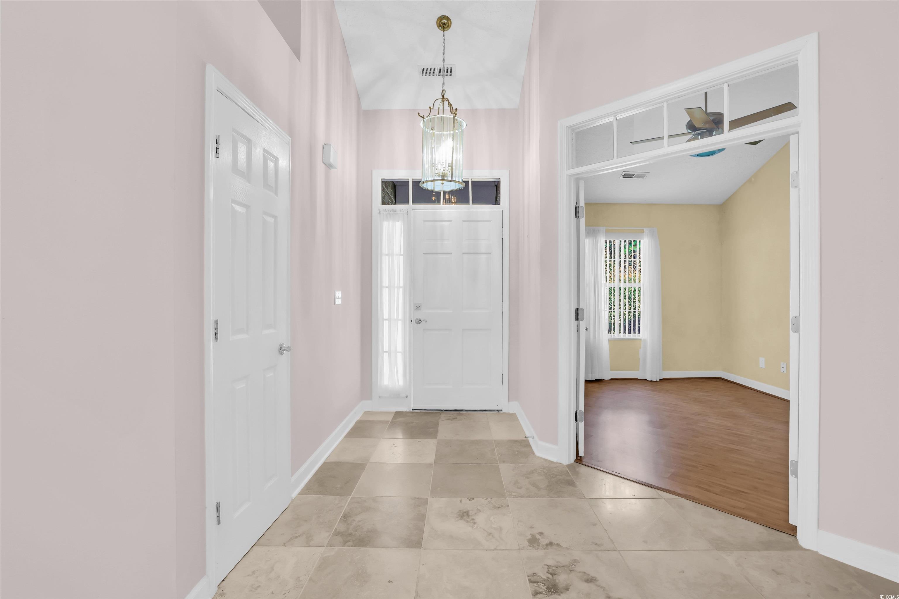 9350 Pinckney Lane Murrells Inlet, SC 29576 - Photo 22 of 40 Foyer featuring light tile patterned floors and a chandelier