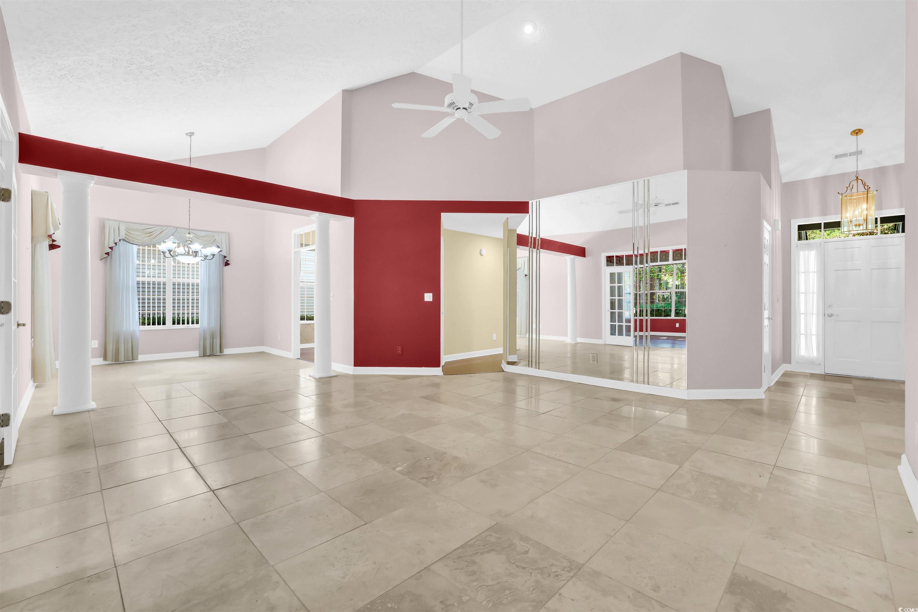 9350 Pinckney Lane Murrells Inlet, SC 29576 - Photo 24 of 40 Unfurnished living room featuring a chandelier, high vaulted ceiling, light tile patterned flooring, a ceiling fan, and a textured ceiling