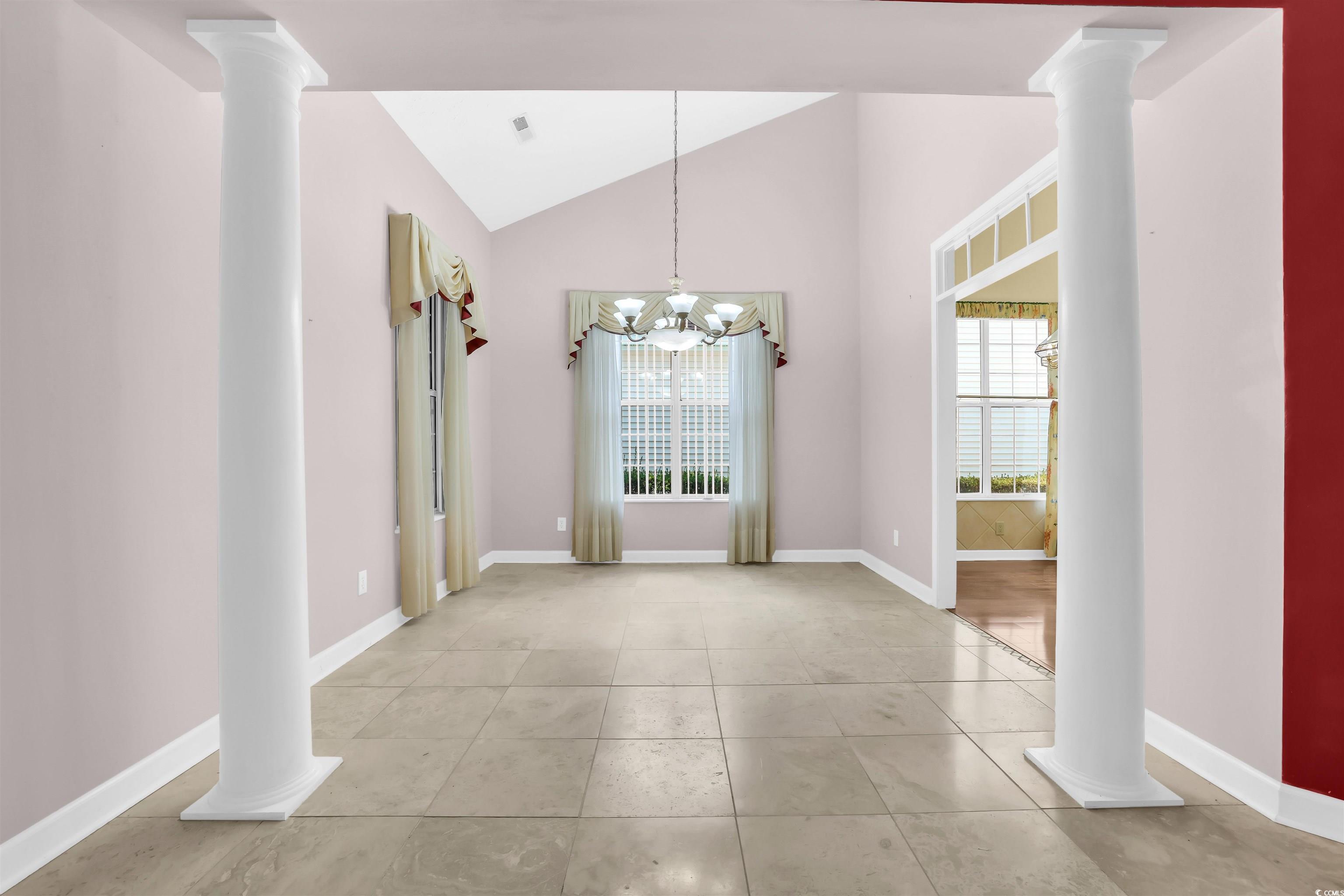 9350 Pinckney Lane Murrells Inlet, SC 29576 - Photo 28 of 40 Unfurnished dining area featuring decorative columns, lofted ceiling, light tile patterned floors, and a chandelier